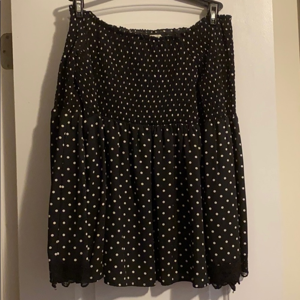 Smocked bodice flared sleeve black polkadot blouse